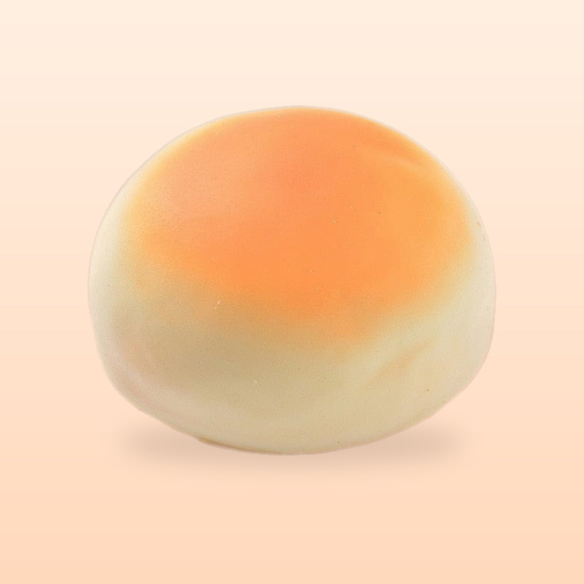 Round bun slow rise bread squishy, on a soft peach background