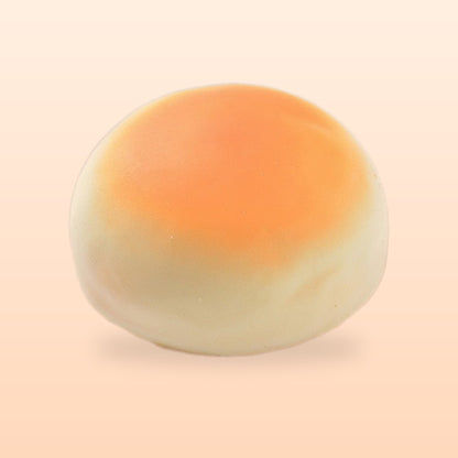 Round bun slow rise bread squishy, on a soft peach background