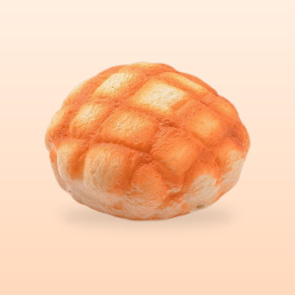 Melon pan bun slow rise bread squishy, on a soft peach background