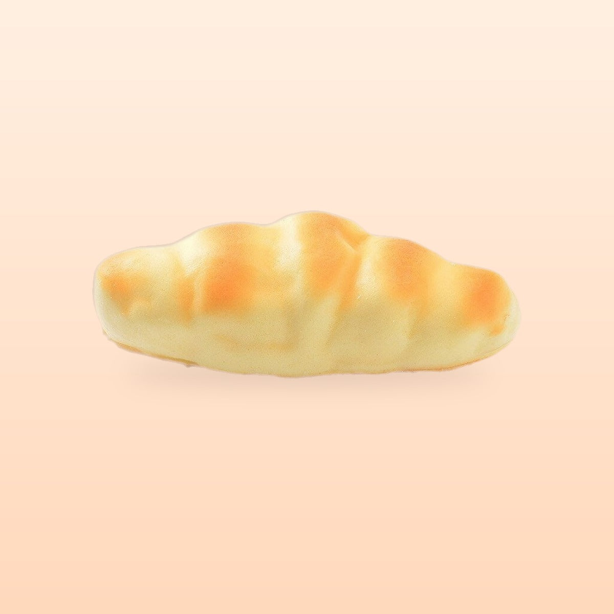 Crescent roll slow rise bread squishy, on a soft peach background