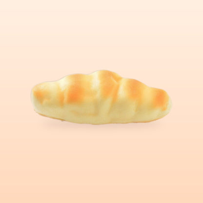 Crescent roll slow rise bread squishy, on a soft peach background