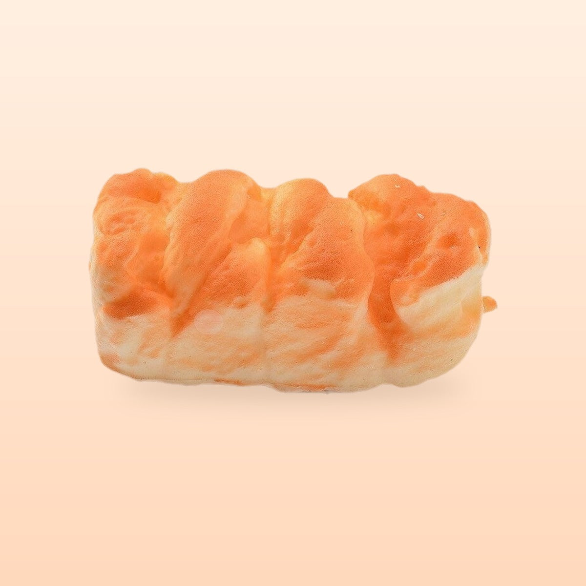 Flaky pastry slow rise bread squishy, on a soft peach background