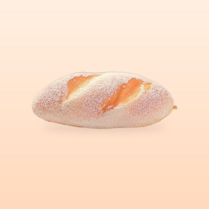 Sugar dusted loaf slow rise bread squishy, on a soft peach background