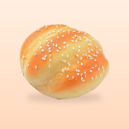 Sesame bun slow rise bread squishy, on a soft peach background