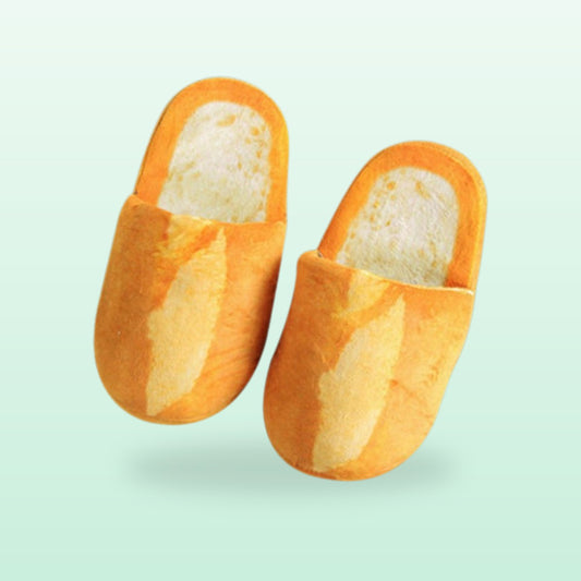 Baguette bread slippers in size large, golden crust with a pale crumb insole, on a mint background