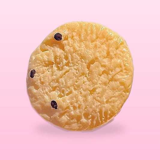 Round cranberry cookie hair clip with little dried cranberry bits, on a pink background