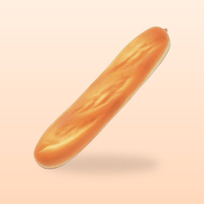 Baguette slow rise bread squishy on a soft peach background