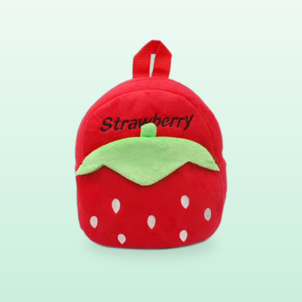 Red strawberry plush mini backpack with a green leaf, front view, on a mint green background