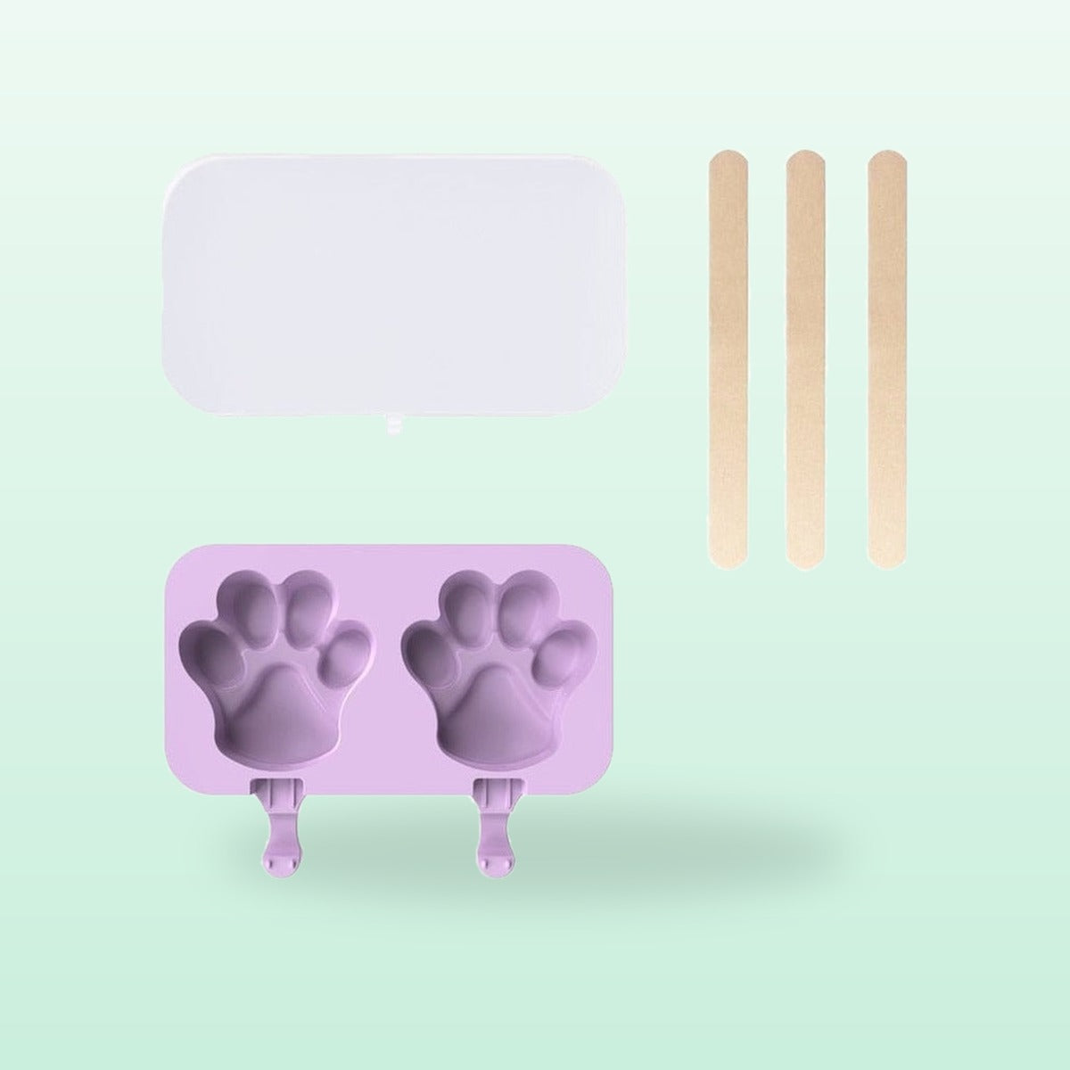 Bear paw silicone ice lolly mould, lilac, with lid and sticks, on a mint green background