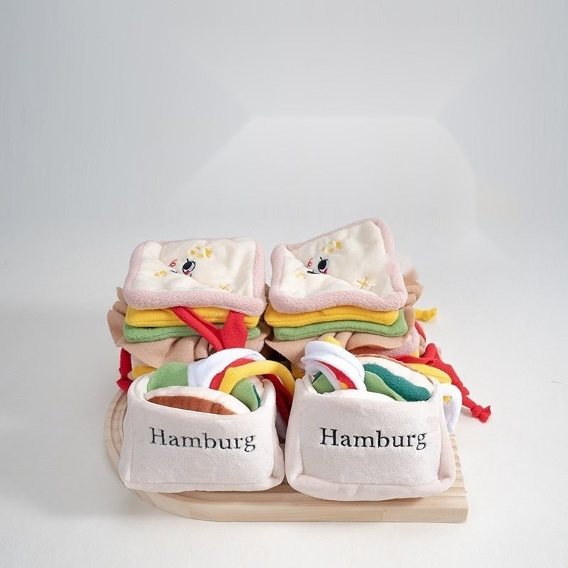 Burger and sandwich pet toys stacked on a wooden board
