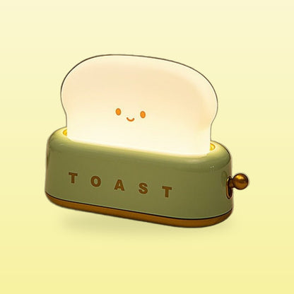 Green toast night light glowing with a smiling face, on a butter yellow background
