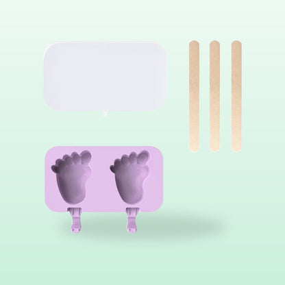 Footprint silicone ice lolly mould, lilac, with lid and sticks, on a mint green background
