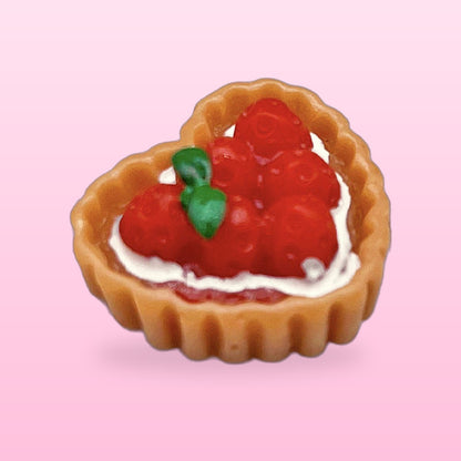 Strawberry heart tart miniature food fridge magnet, on a pink background