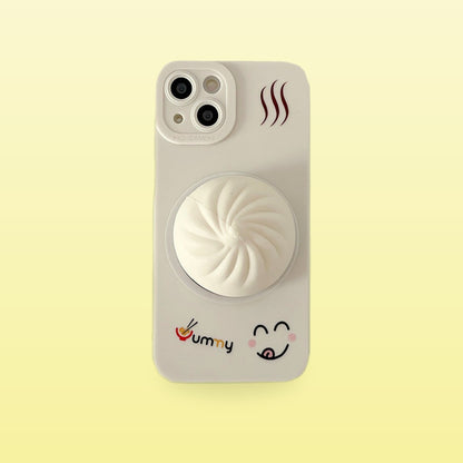 White squishy bao bun iPhone case with Yummy lettering, on a butter yellow background