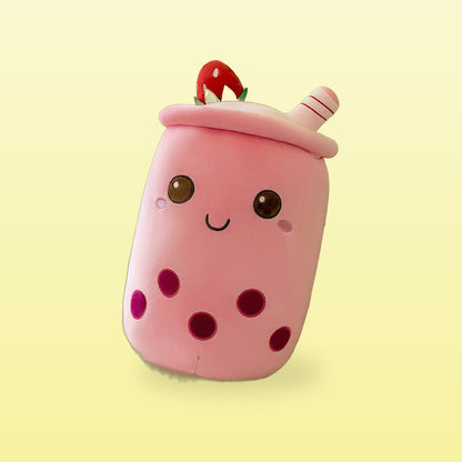Strawberry milk tea plush pillow, pink cup with a strawberry on the lid, on a butter yellow background