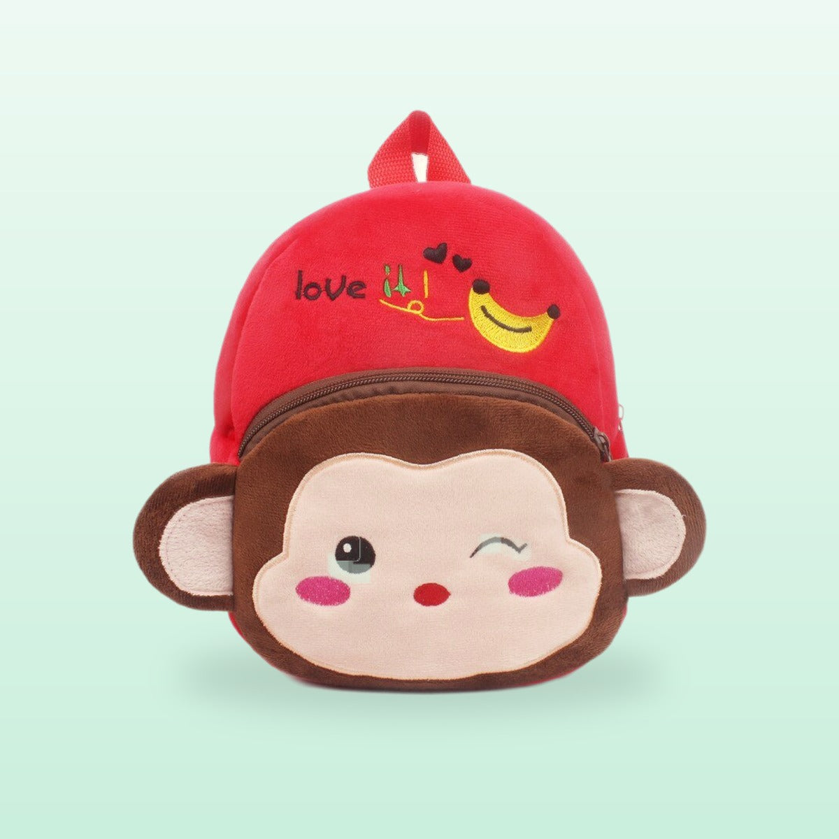 Monkey plush mini backpack with a winking face and a red top, on a mint green background