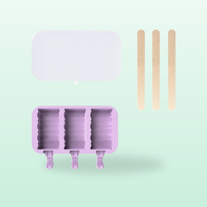 Building blocks silicone ice lolly mould, lilac, with lid and sticks, on a mint green background
