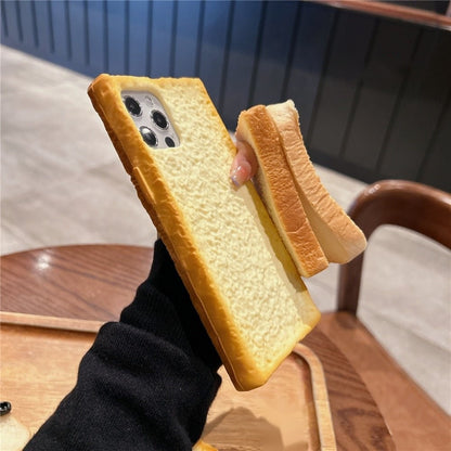 Toast bread iPhone case held on its side beside a real slice of bread
