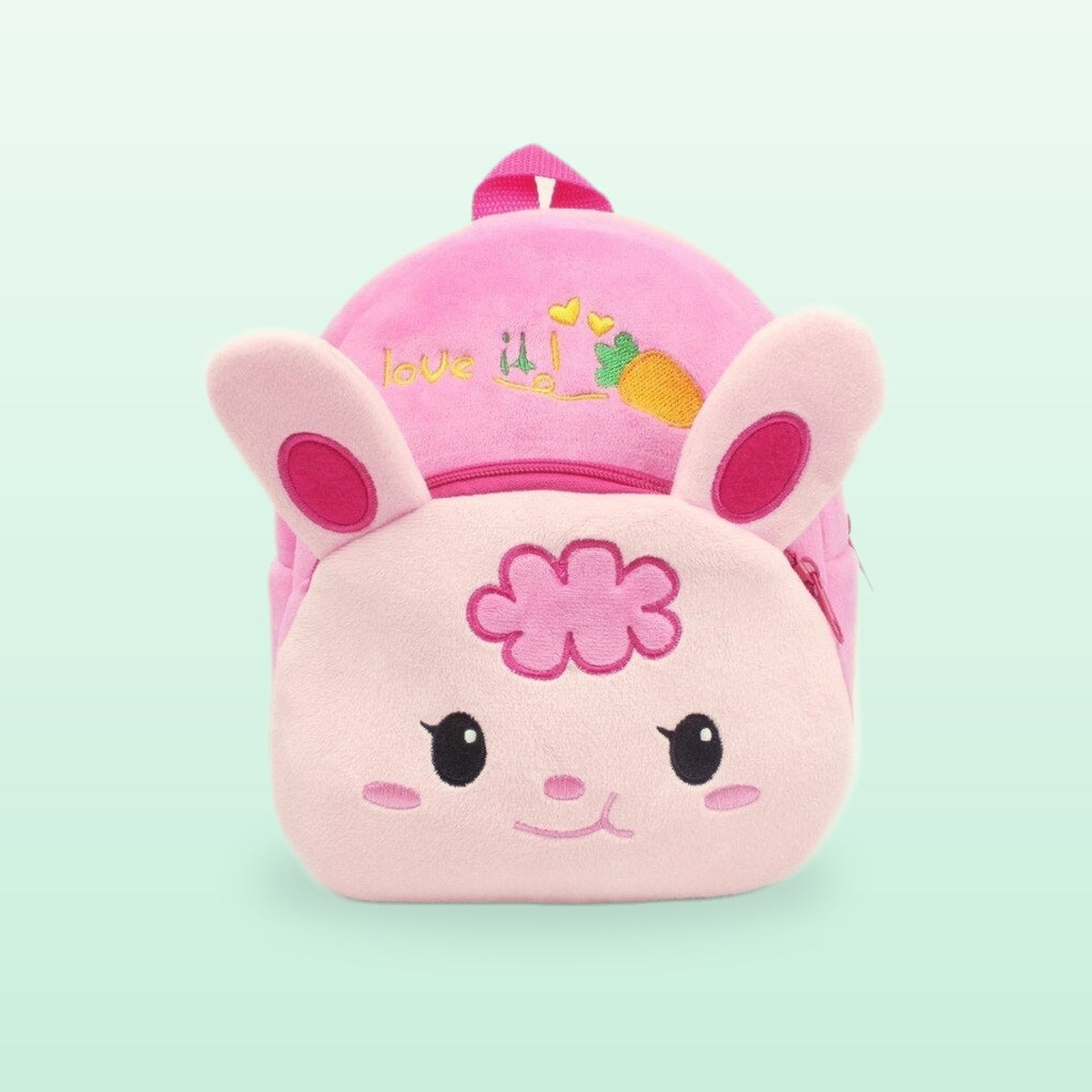 Pink bunny plush mini backpack with floppy ears and a flower, on a mint green background