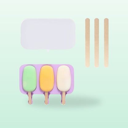 Classic oval silicone ice lolly mould with three lollies, lid and sticks, on a mint green background