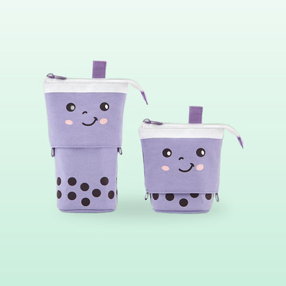 Purple boba milk tea pen pouch with a winking face, shown tall and folded down, on a mint background