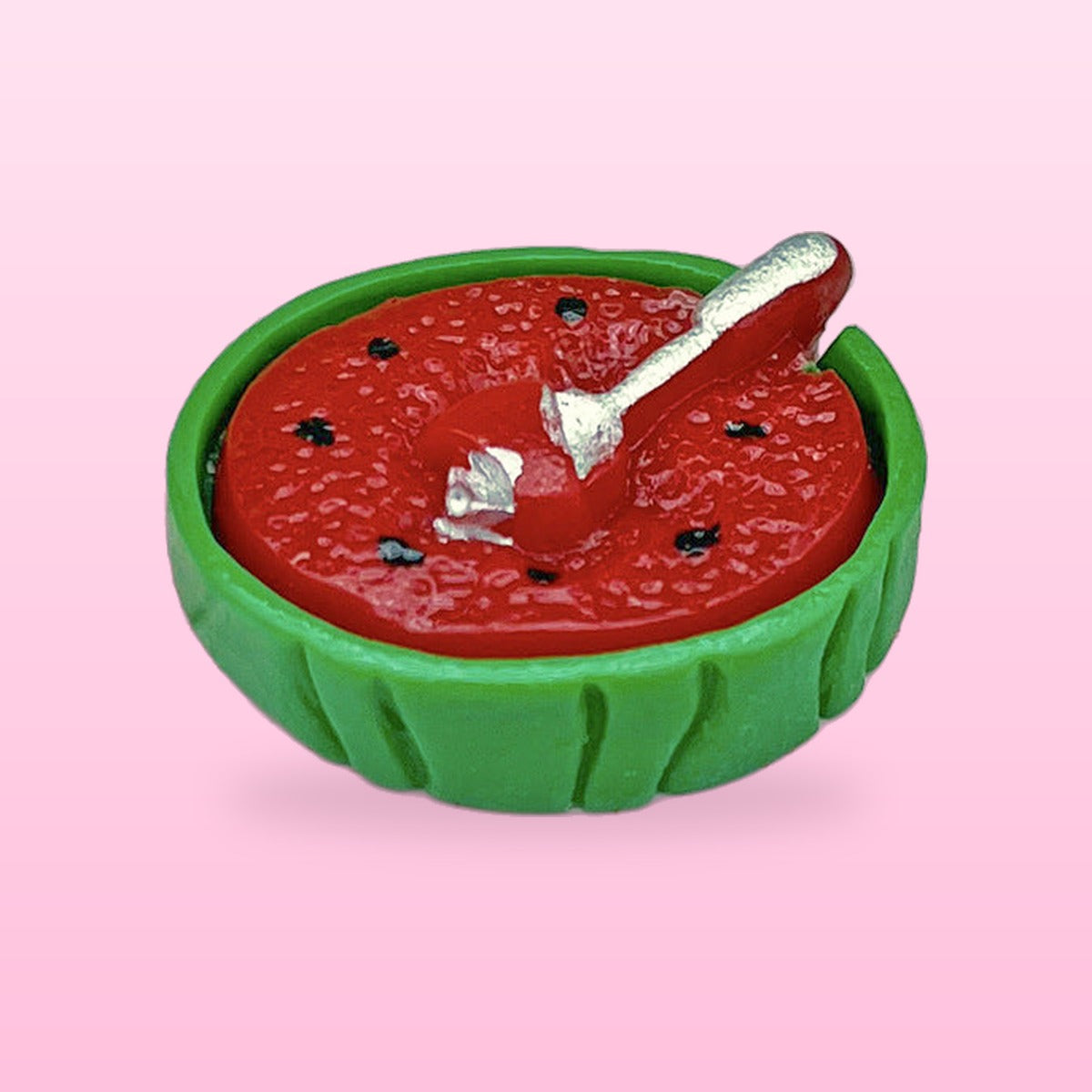 Watermelon bowl miniature food fridge magnet with a tiny silver spoon, on a pink background