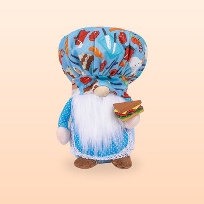 Blue hamburger chef plush gnome with a food print hat, white beard and a sandwich, on a peach background