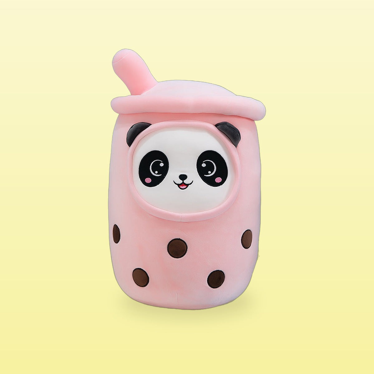 Panda milk tea plush pillow, pink cup with a panda face and pink straw, on a butter yellow background