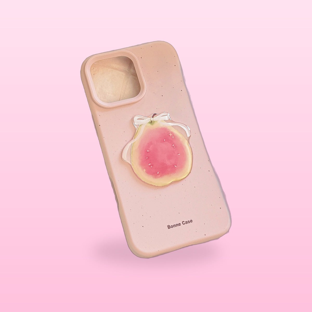 3D fruit iPhone case, dusty pink with a guava half and white bow, on a pink background