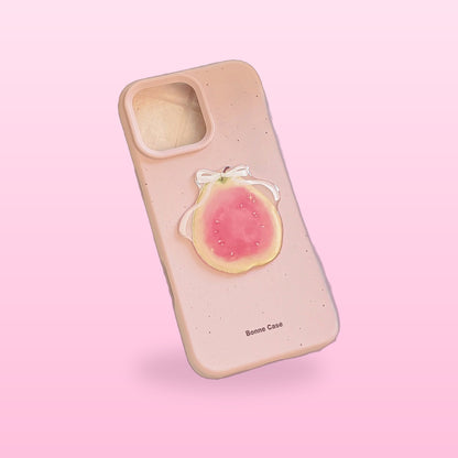 3D fruit iPhone case, dusty pink with a guava half and white bow, on a pink background