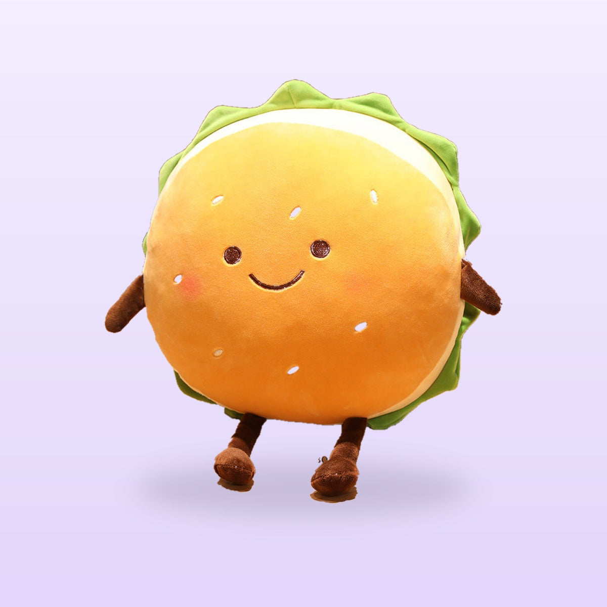 Smiley burger plush cushion with rosy cheeks and brown legs, on a soft lilac background