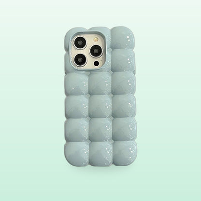 Bubble block iPhone case in pale blue with puffy glossy squares, back view on a mint background