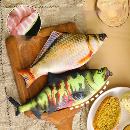 Salmon and carp fish pencil cases side by side on a chopping board