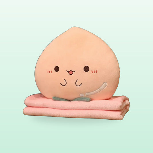 Peach plush pillow with a smiling face on its folded pink blanket, on a mint green background