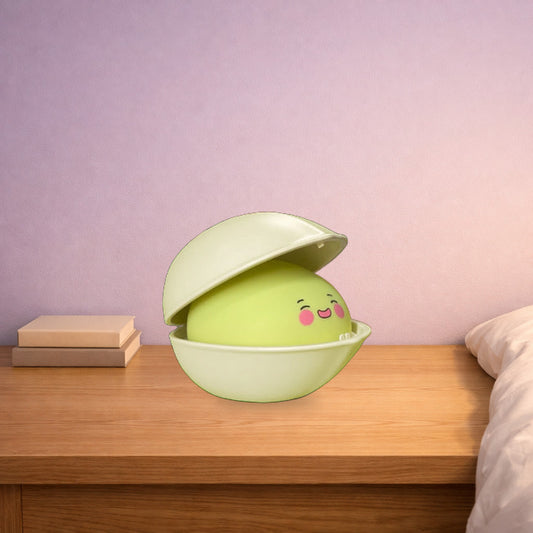 Pistachio night light with a smiling face on a wooden bedside table