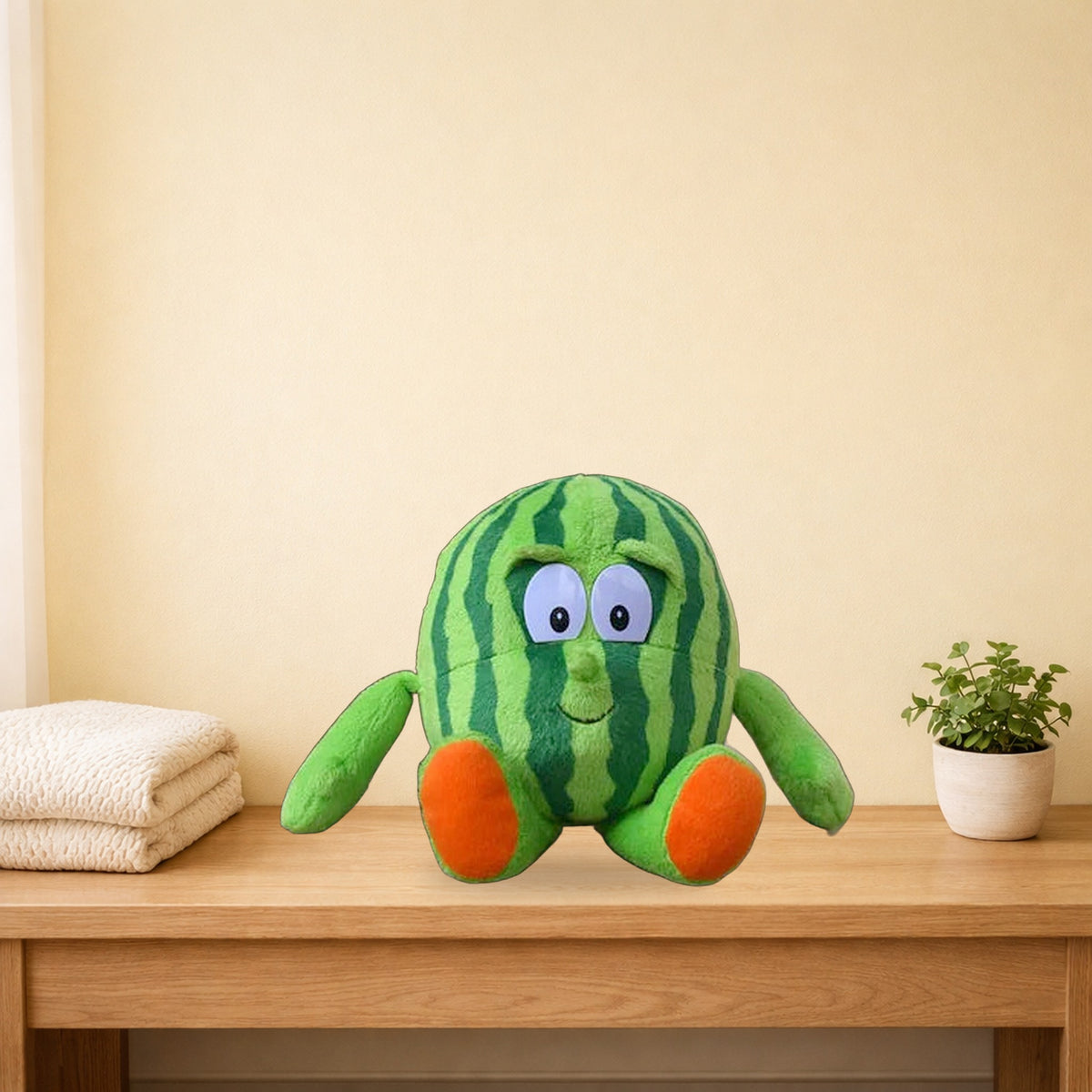Watermelon fruit and veg buddies plush sitting on a light oak bench