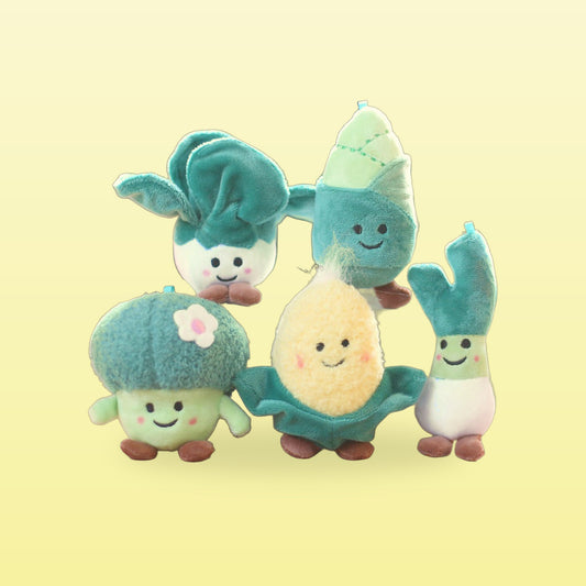 Five plush veg charms, bok choy, bamboo shoot, broccoli, corn and spring onion, grouped on a butter yellow background