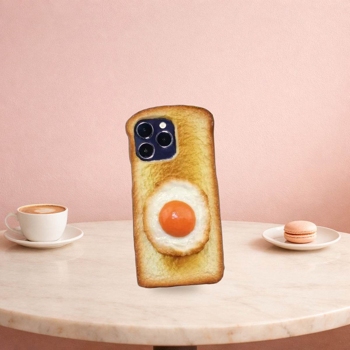 Fried egg toast iPhone case standing on a pink cafe table