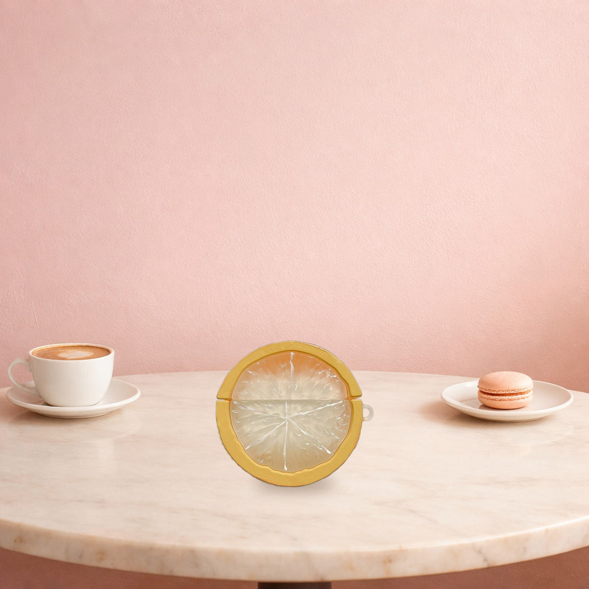 Yellow lemon slice AirPods case on a marble cafe table