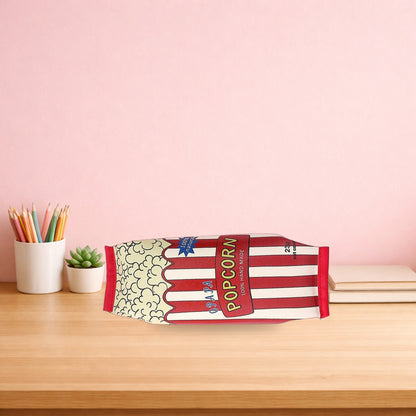 Popcorn snack packet pencil case lying on a light oak desk