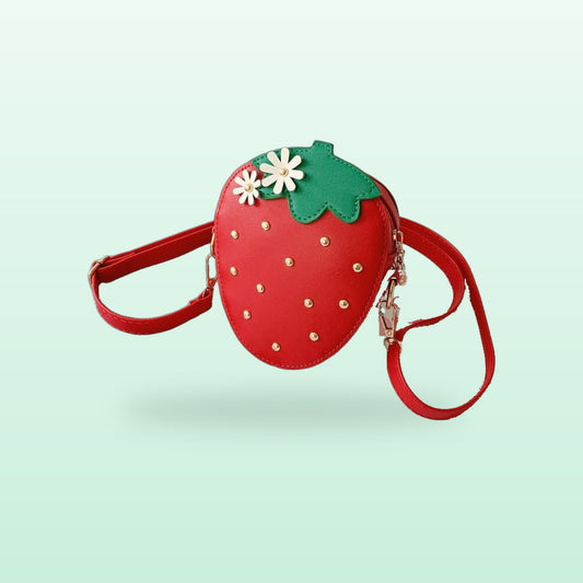 Red strawberry crossbody bag with daisies and gold studs, on a mint green background