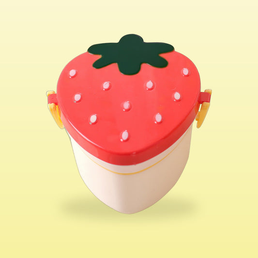 Red strawberry double layer lunch box with yellow side clips, closed, on a butter yellow background