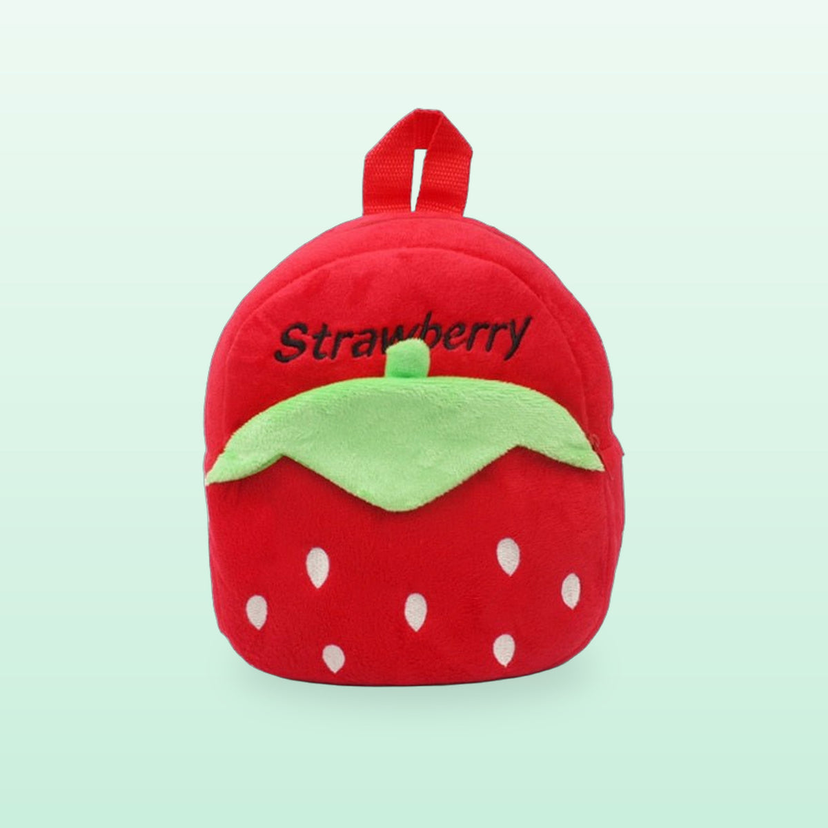 Red strawberry plush mini backpack with a green leaf, front view on a mint green background