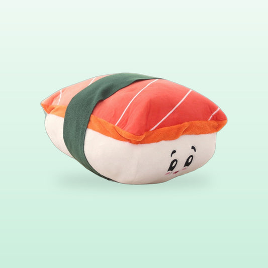 Salmon sushi plush pet toy with a green seaweed band and a smiling face, on a soft mint background