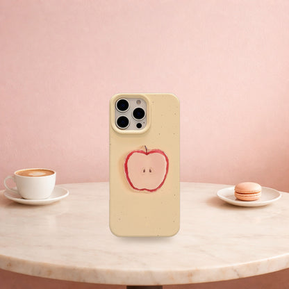 Cream yellow 3D apple iPhone case standing on a marble cafe table