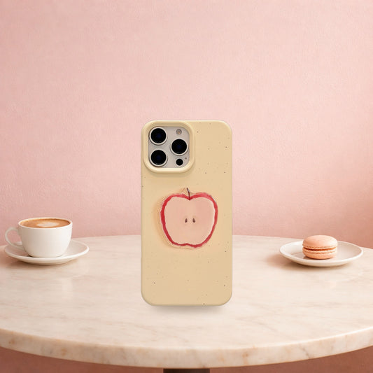 Cream yellow 3D apple iPhone case standing on a marble cafe table