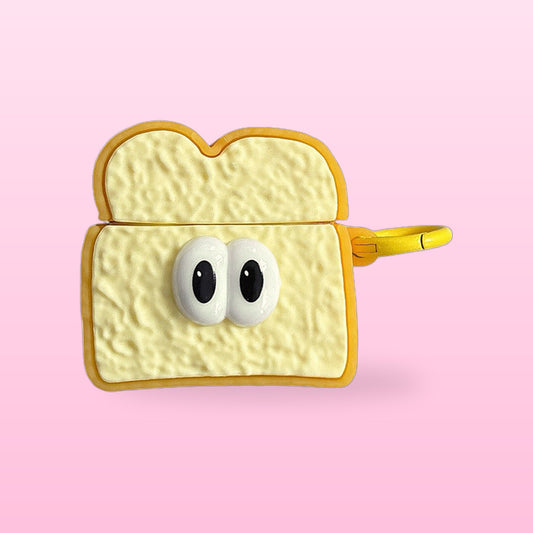 Toast slice AirPods case with googly eyes and a yellow clip, on a pastel pink background