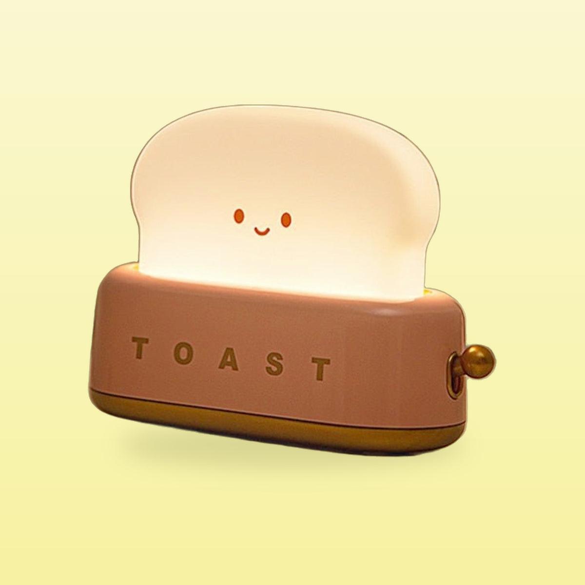 Pink toaster night light with a glowing smiling toast slice on a butter yellow background