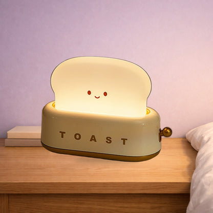 Green toaster night light glowing on an oak bedside table