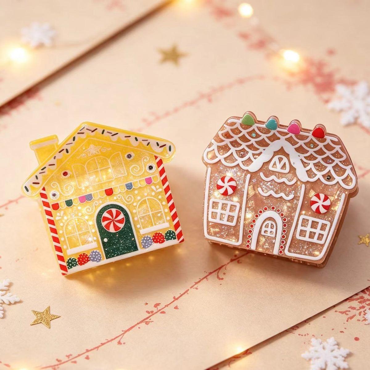 Two gingerbread house hair clips on a festive card with fairy lights and snowflakes